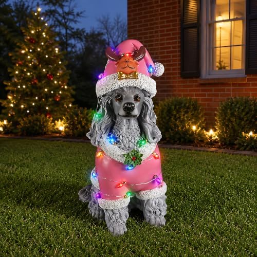 lighted christmas poodle statue, pink outfit on a desk or shelf