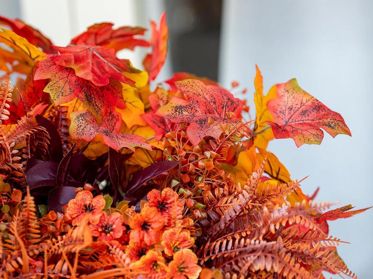 artificial fall flowers outdoors, faux maples & mums, side view