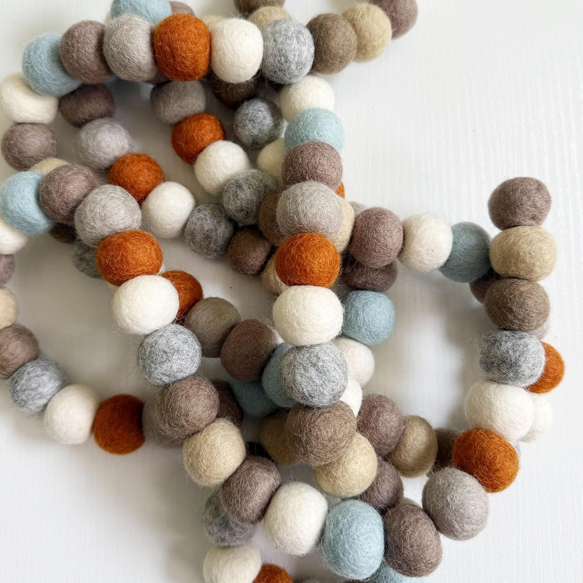 large natural felt ball garland, pom pom decor shown in use